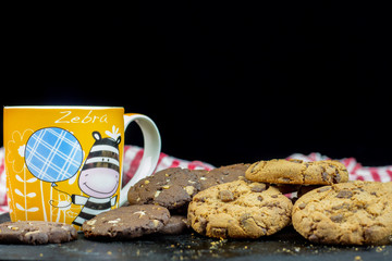 Chocolate chips cookies and mug of milk