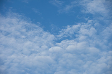 blurred white clouds in the blue sky. 