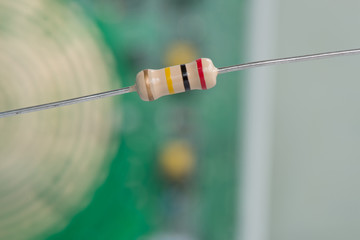 Closeup 200K or 200,000 Ohms resistors against electronic board.
