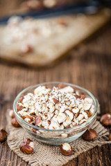 Some chopped Hazelnuts on wooden background