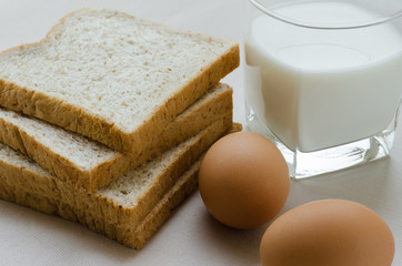 Sliced Whole Wheat Bread, Boiled Egg and Milk for Breakfast.