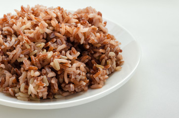 Brown Rice On White Plate.