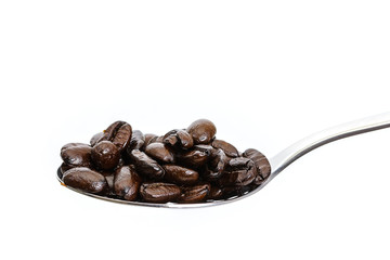 spoon with coffee beans. isolated white background.