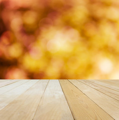 Naklejka na ściany i meble Blank area or space wooden table top on bokeh orange and yellow spring background