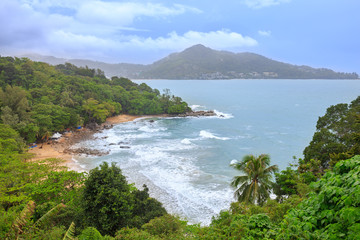 Tropical sandy beach landscape from high view point. Beautiful turquoise ocean and people relaxing in Laem Sing and Kamala beach Phuket, Thailand