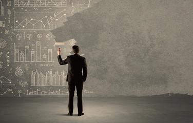 Salesman painting over charts on wall