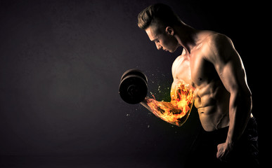 Bodybuilder athlete lifting weight with fire explode arm concept