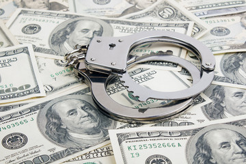 Lot of one hundred dollar bills and handcuffs.