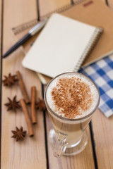 latte and notepad on a  wooden background