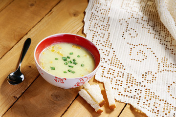 Cream soup, spoon and bread croutons
