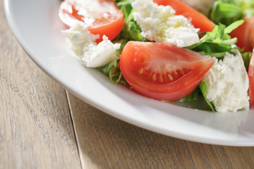 summer light salad with tomatoes, mozzarella and rocket leaves