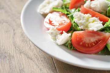 summer light salad with tomatoes, mozzarella and rocket leaves