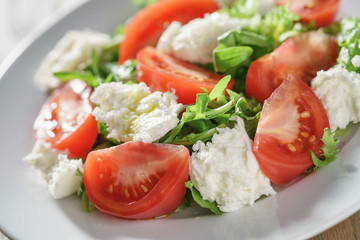 summer light salad with tomatoes, mozzarella and rocket leaves
