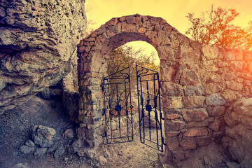 Open gate in rock at sunset
