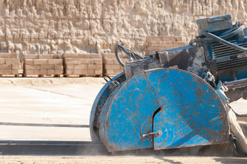 Circular sawing machine in action in a tufa quarry while carving the stone