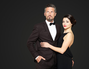 Happy mature couple on dark background