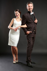 Happy mature couple on dark background