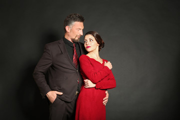 Happy mature couple on dark background