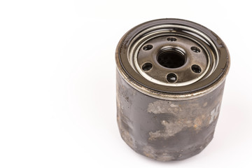 Old used car oil filter isolated over white background