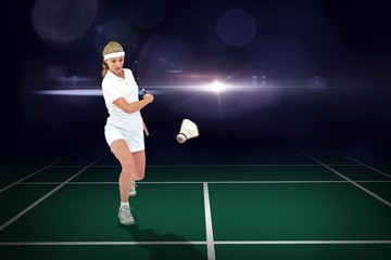 Fototapeta na wymiar Composite image of badminton player playing 
