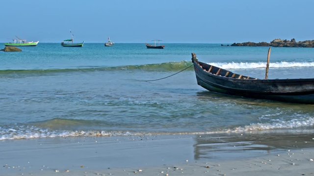 Fisherman boats on sand and anchored on the Ngapali beach panorama, Myanmar