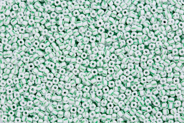 Obraz premium White beads with green lines.