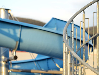 Detail of spiral stairs to water slide at sunset