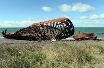 Rusty ship on the shore of the Strait of Magellan in the village of San Gregorio.