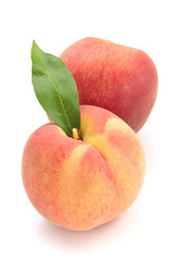 Ripe peaches with leaves.