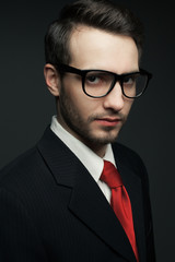 Eyewear concept. Portrait of young handsome man in black suit