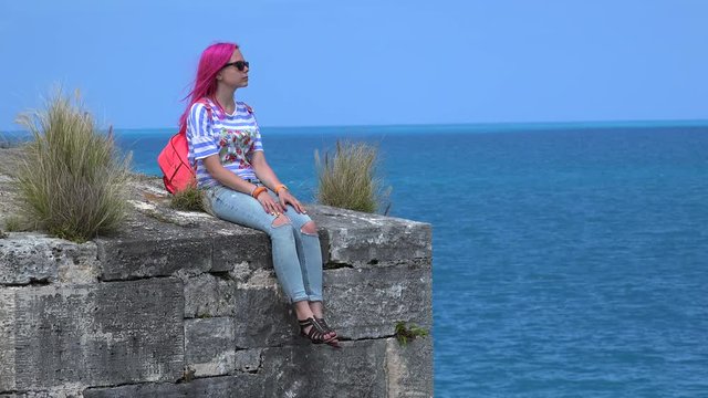 Girl at the Fortress wall in the National museum of Bermuda in Royal Naval Dockyard.