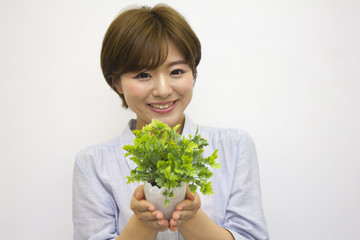植木鉢を持つ若い女性