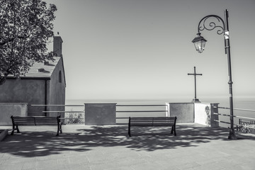 Black and White Photo with Benches, Simple Church and Cross look