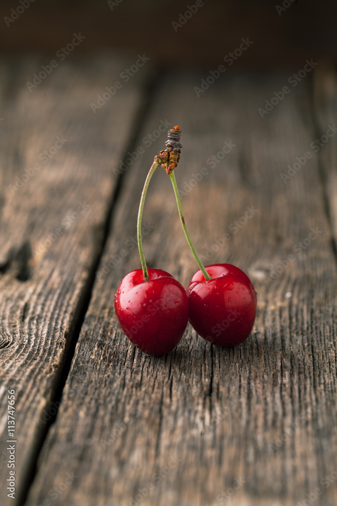 Sticker ripe cherry on a board