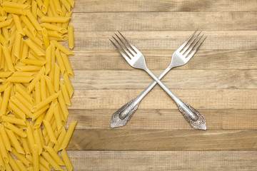 two fork cross lay on wooden background