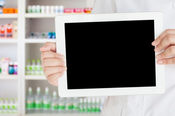 pharmacist showing blank digital tablet computer in the pharmacy