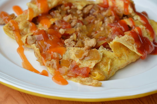 stuffed omelet with onion and minced pork dressing sauce on plate