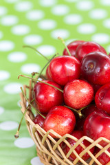 Closeup macro cherries in the basket blurred background