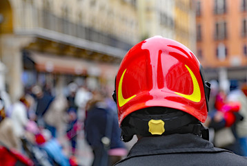 Chief of firefighters with red Hardhat checking people