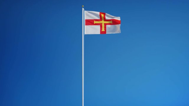 Guernsey flag waving in slow motion against clean blue sky, seamlessly looped, long shot, isolated on alpha channel with black and white luminance matte, perfect for film, news, digital composition