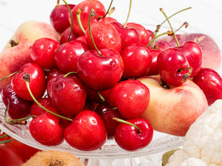 cherries and peaches on white wooden table