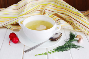 Chicken soup in white bowl