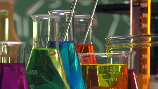 Pouring yellow liquid in a beaker