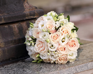 Bridal bouquet of roses on a granite parapet