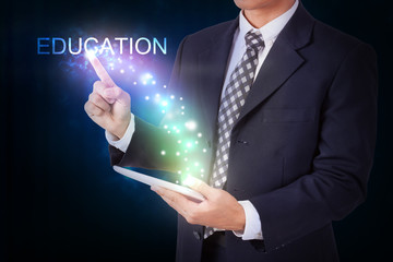 Businessman holding tablet with pressing education. internet and networking concept