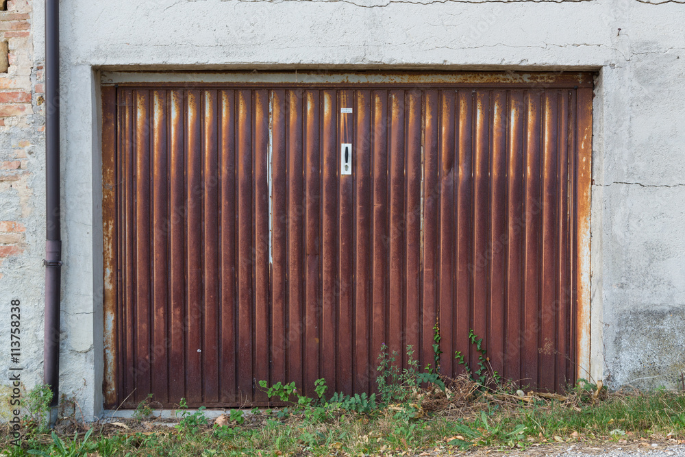 Poster abandoned and rusty rolling shutter