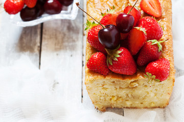 Fruitcake with strawberry and cherry topping