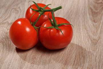 Tomatoes, bunch of vegetables on a wooden table