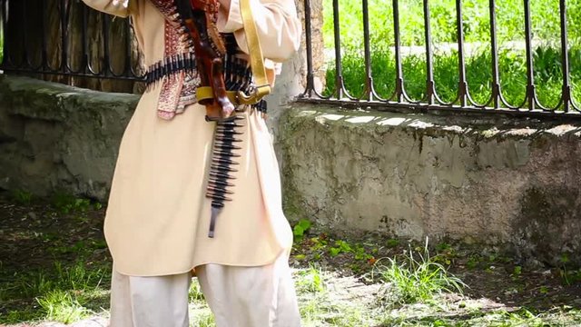 terrorist with a machine gun in a city park