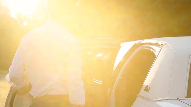 Girl with a guy sit in a limousine.